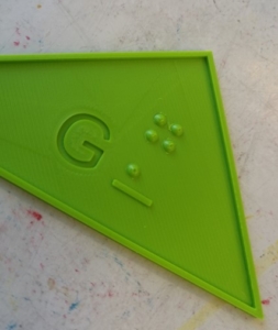 triangel with G and G in braille