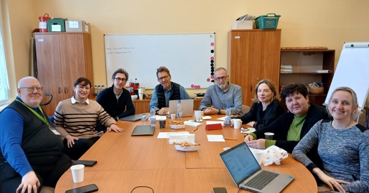 Photo of the board members, meeting aroud a table